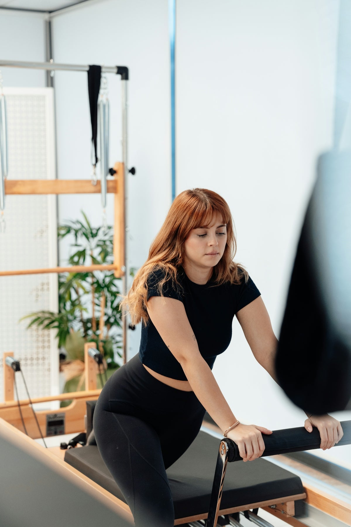 a woman on a rowing machine in a gym
