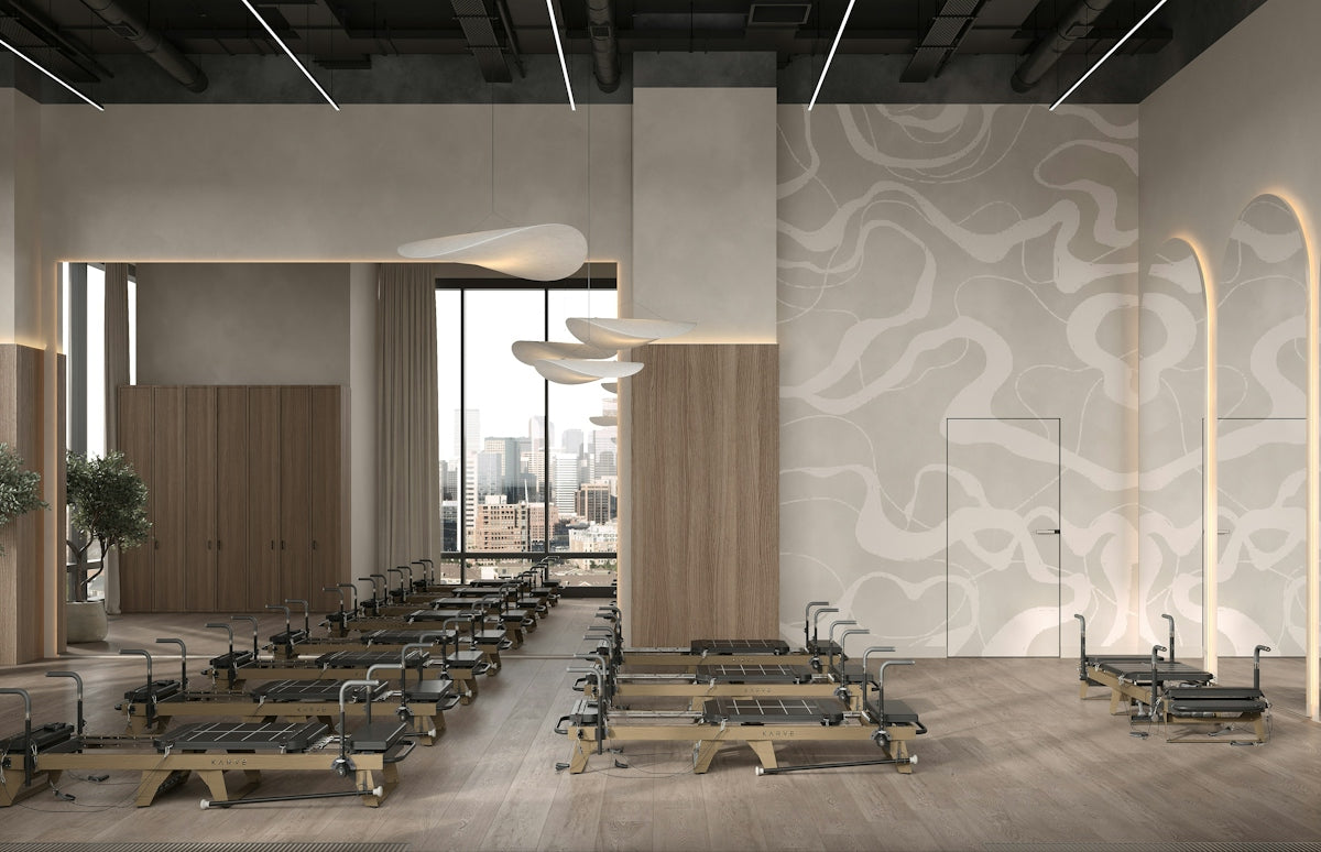 Modern pilates studio with reformer machines and elegant design.